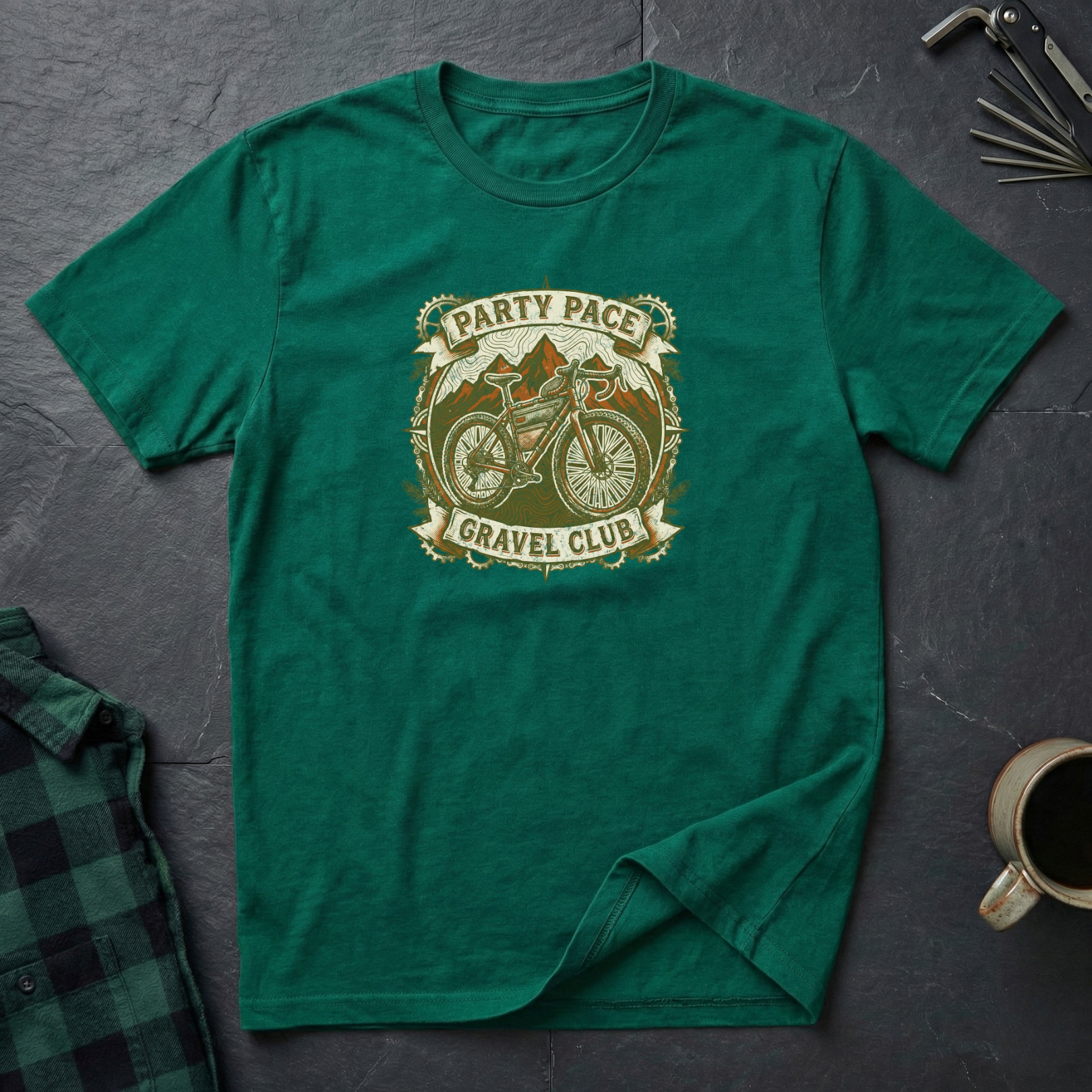 Green cycling t-shirt with 'Party Pace Gravel Club' graphic on a dark surface.